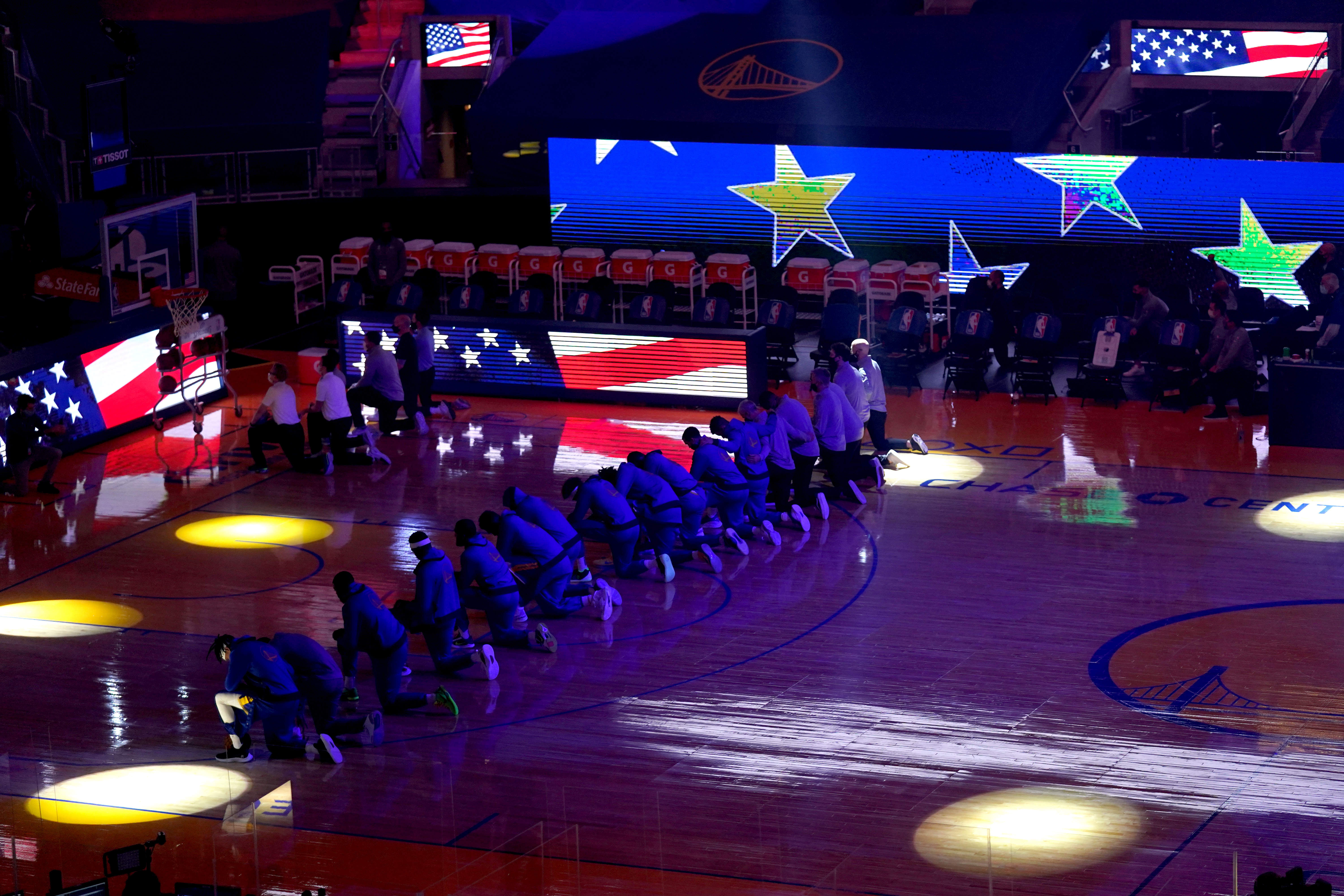 Players from the Golden State Warriors kneel during the national anthem before the start of the game against the Los Angeles Clippers at the Chase Cente. Credit: Reuters Photo