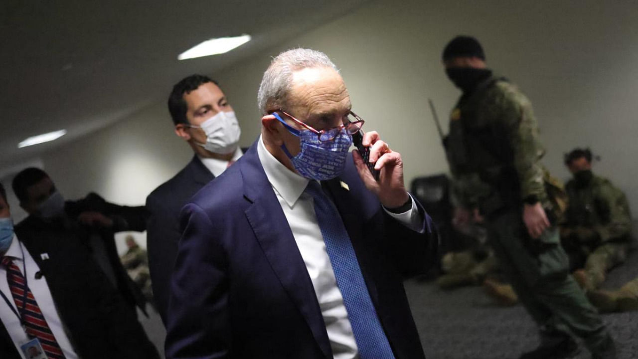 Senate Minority Leader Chuck Schumer (D-NY) walks to a room on Capitol Hill where senators gathered on January 06, 2021 in Washington, DC. Credit: AFP.