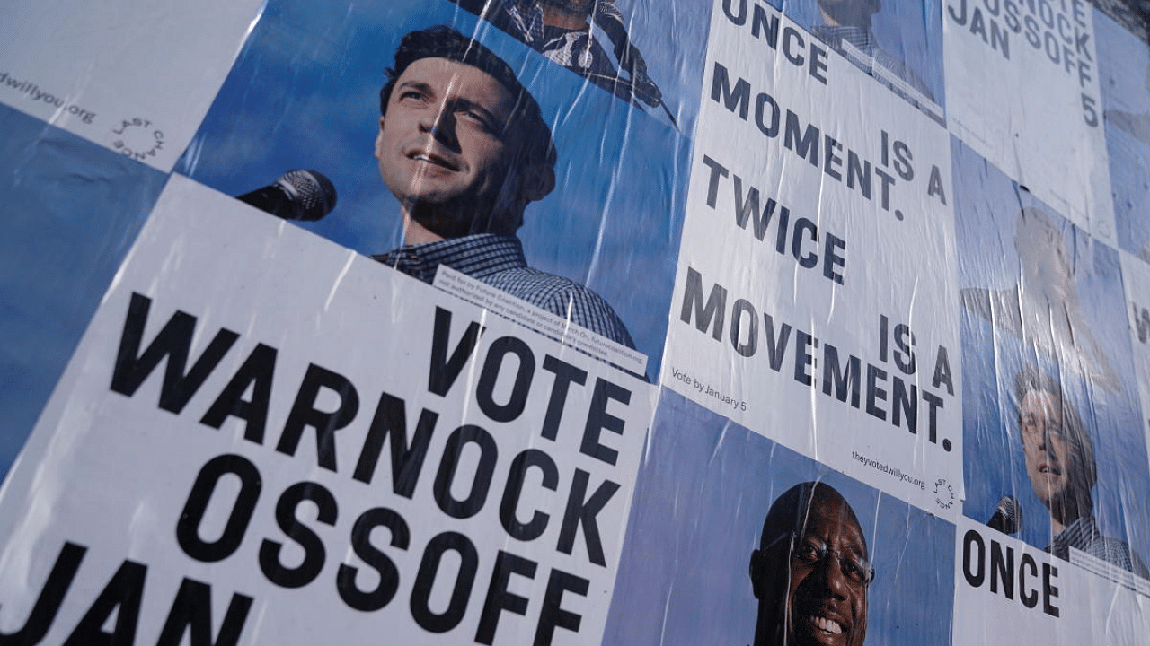 Campaign ads for Jon Ossoff and Raphael Warnock are seen on a wall near the John Lewis mural the day after the US Senate runoff elections in Atlanta, Georgia, US. Credit: Reuters Photo