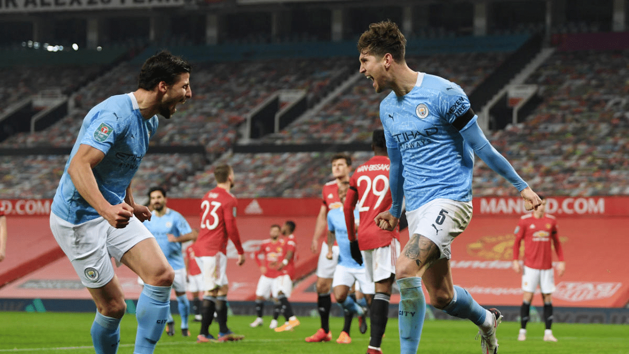 Manchester City's John Stones celebrates scoring their first goal with teammates in a 2-0 win over Manchester United in the League Cup semifinals at Old Trafford, Manchester. Credit: Reuters Photo