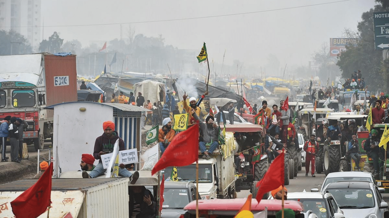  Farmers on their way to Tikri border during a tractor rally as part of their ongoing protest against the new farm laws, at Eastern Peripheral Expressway in New Delhi. Credit: PTI Photo