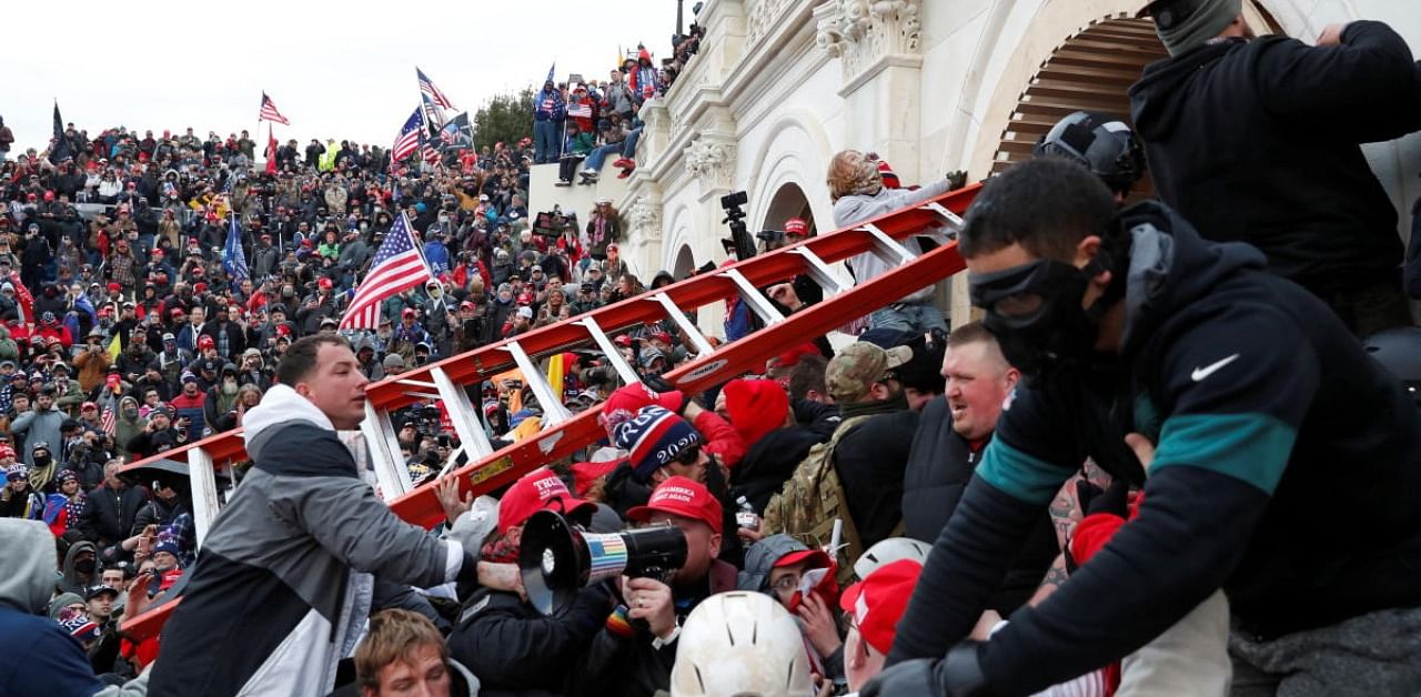 Rioters, many bearing Trump garb, breached the barricades set up by an under-staffed police force and swarmed the Capitol, disrupting the certification of President-Elect Joe Biden’s election. Credit: AFP Photo