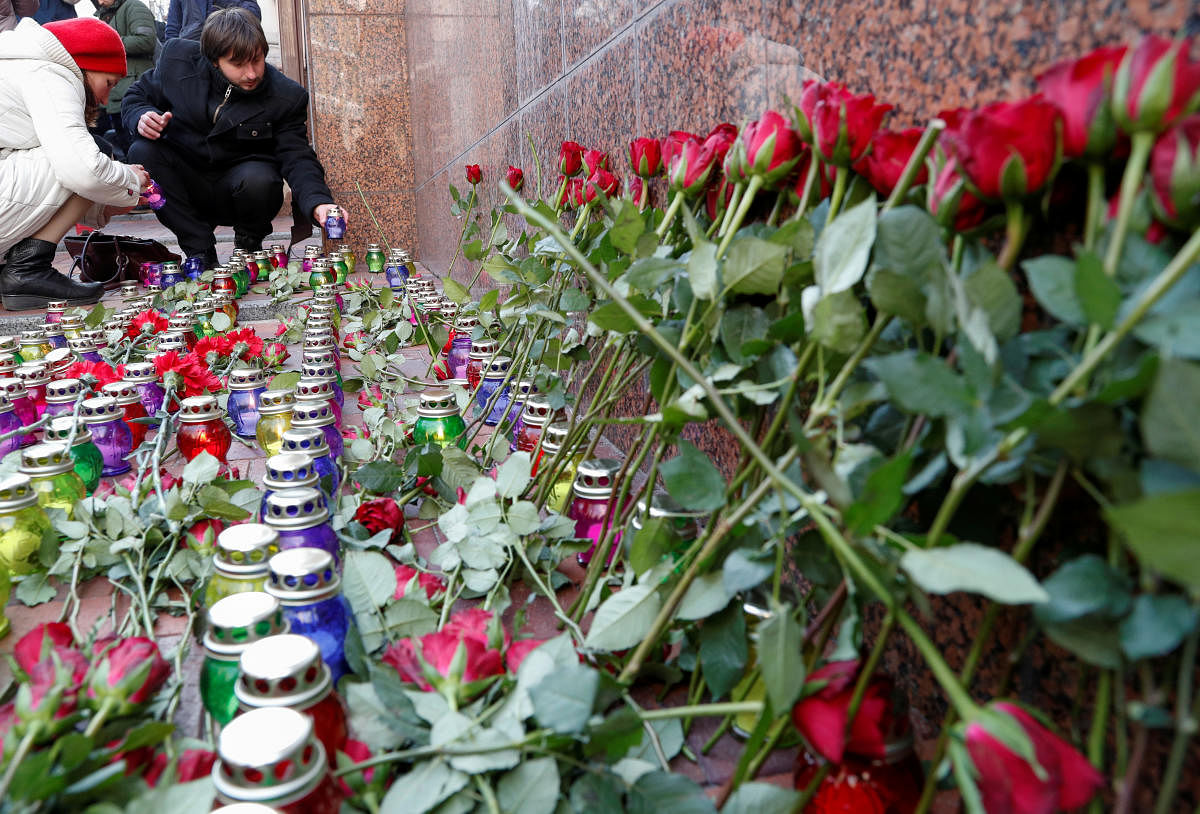 People place candles as they commemorate victims of the Ukraine International Airlines flight 752 plane disaster, in front of the Iranian embassy in Kiev, Ukraine February 17, 2020. Credit: REUTERS