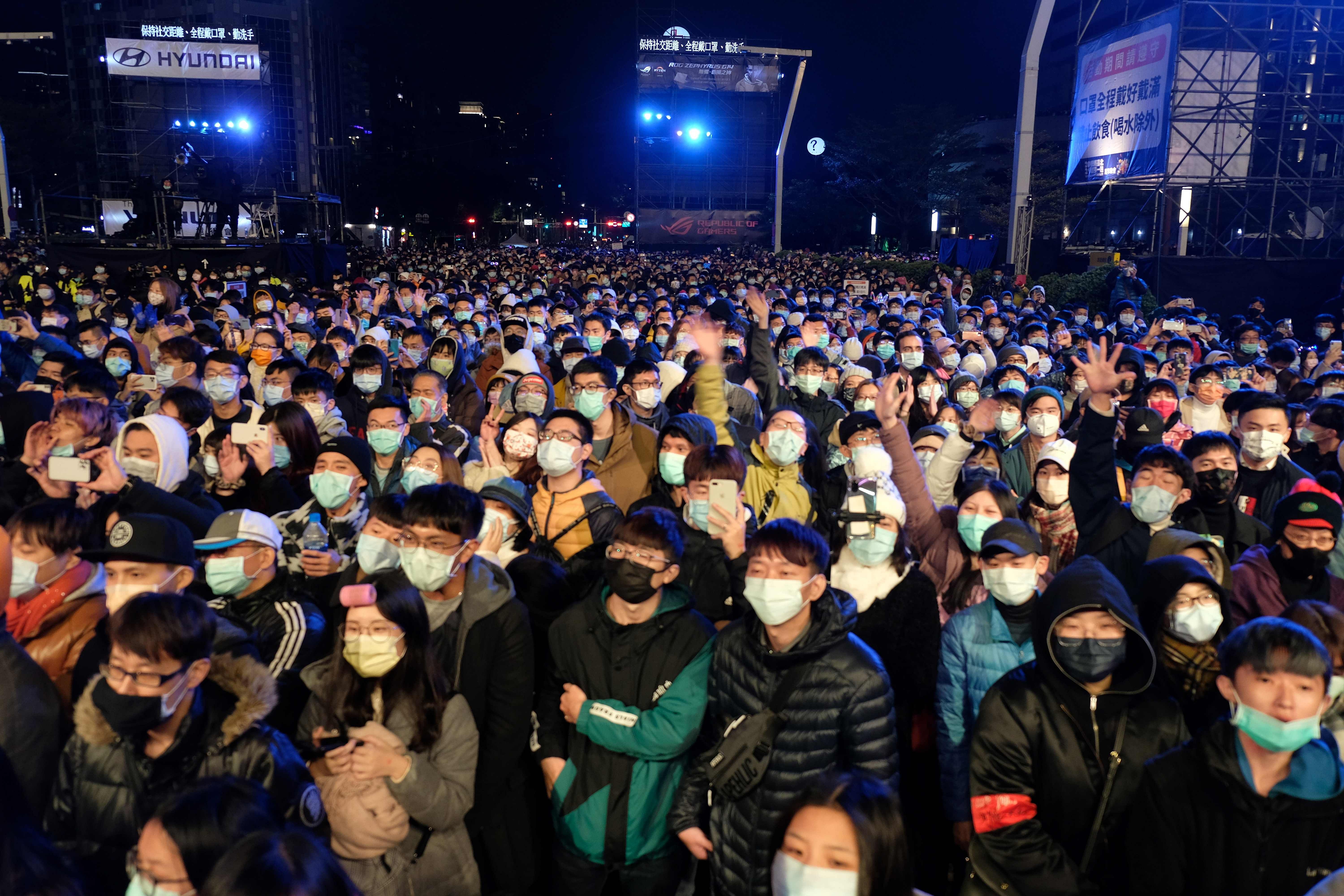 Masked people take part in the New Year celebrations next to the Taipei 101 commercial building in Taipei on January 1, 2021. Credit: AFP Photo