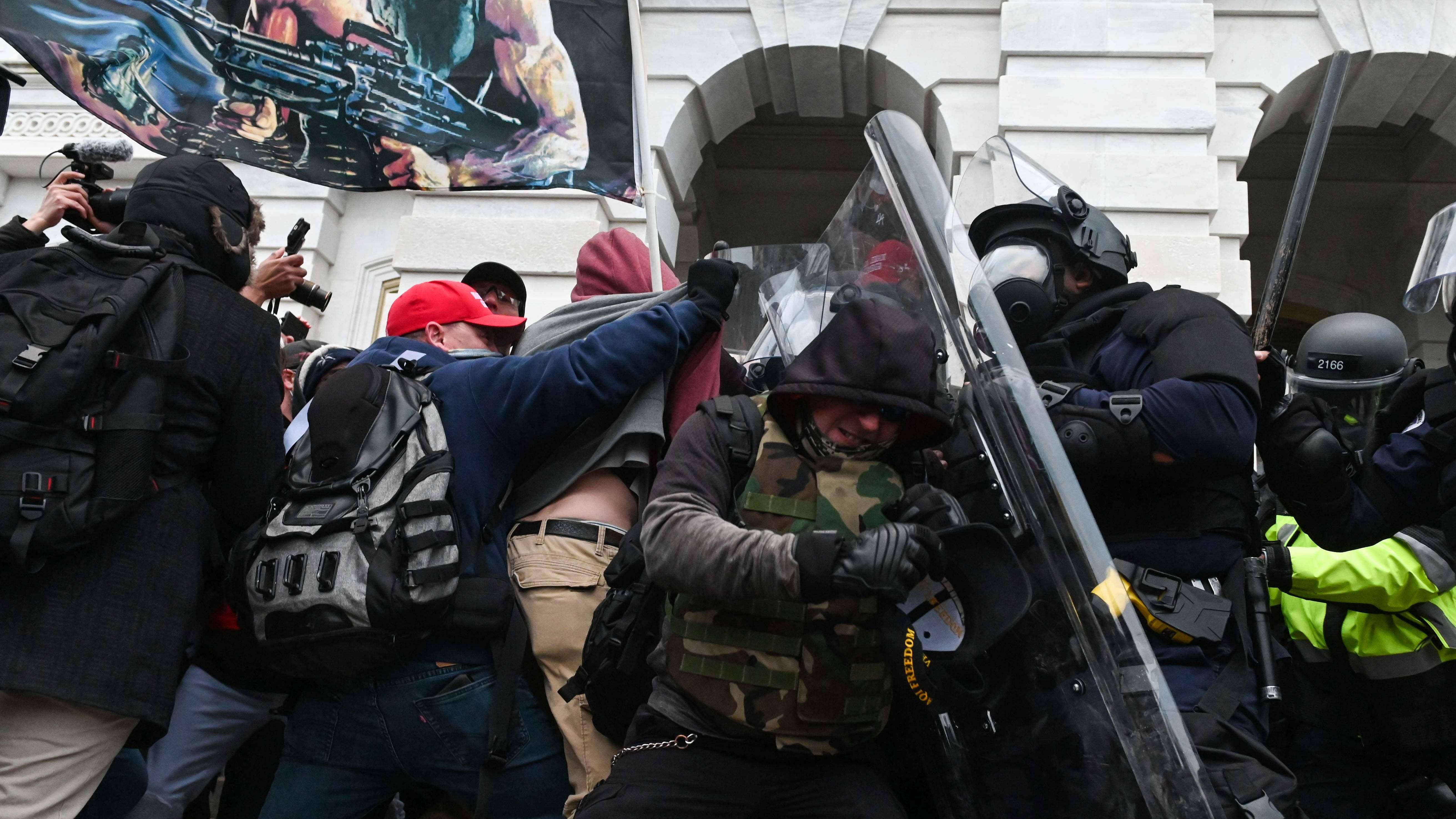 Riot police push back a crowd of supporters of US President Donald Trump after they stormed the Capitol building in Washington, DC. Credit: AFP