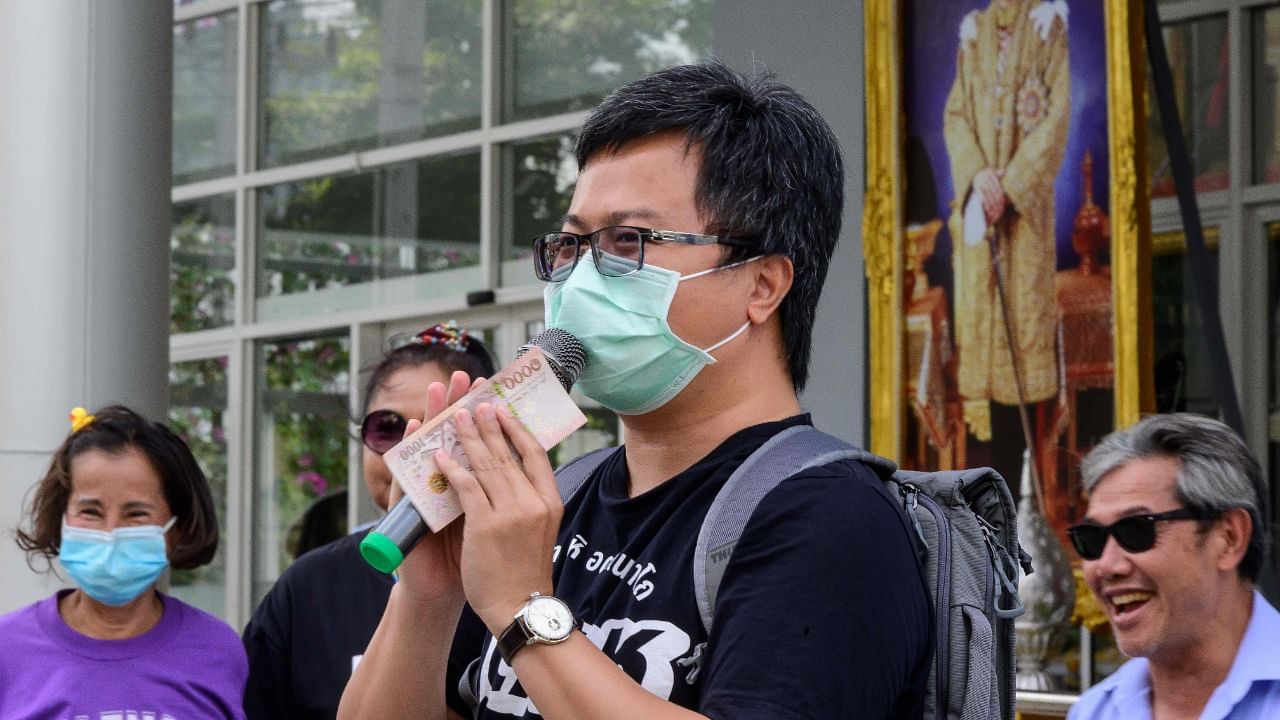 Pro-democracy activist Anon Numpa sings to his supporters outside Pathum Wan police station in Bangkok on January 8, 2021, after hearing charges related to organizing anti-government protests in 2020. Credit: AFP Photo