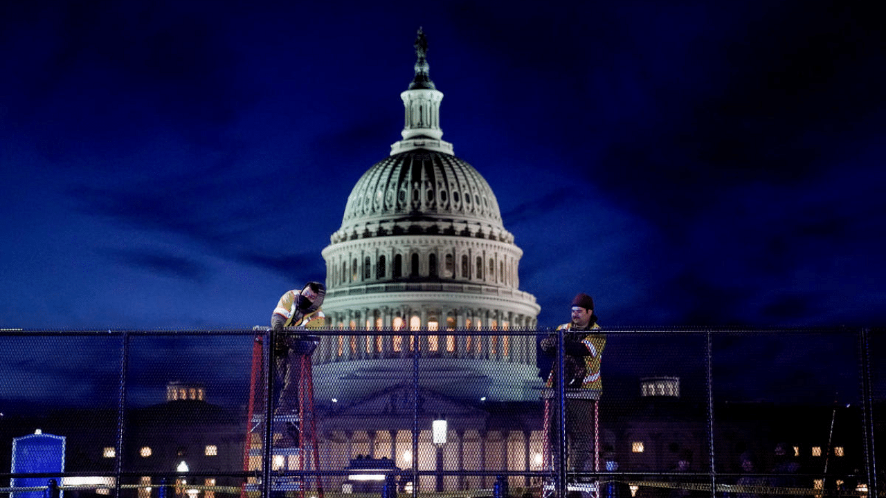 Workers install heavy-duty security fencing around the US Capitol a day after supporters of US President Donald Trump stormed the Capitol in Washington, US. Credit: Reuters File Photo