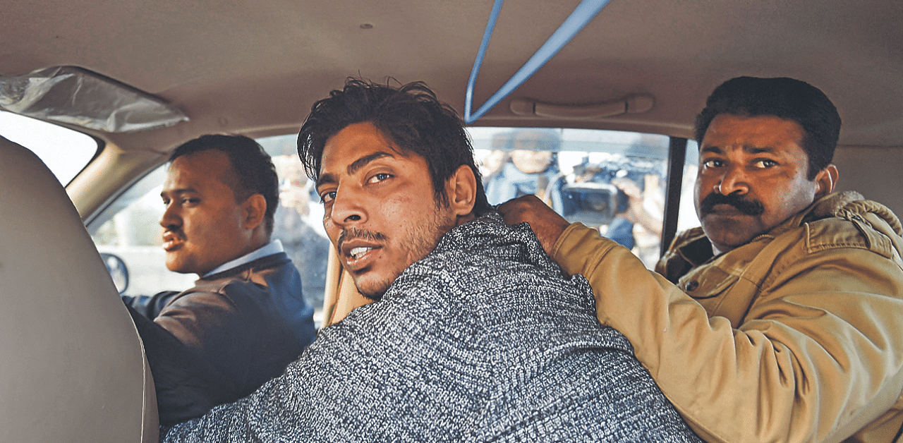 Police take away man after he allegedly opened fire in the Shaheen Bagh area of New Delhi. Credit: PTI Photo