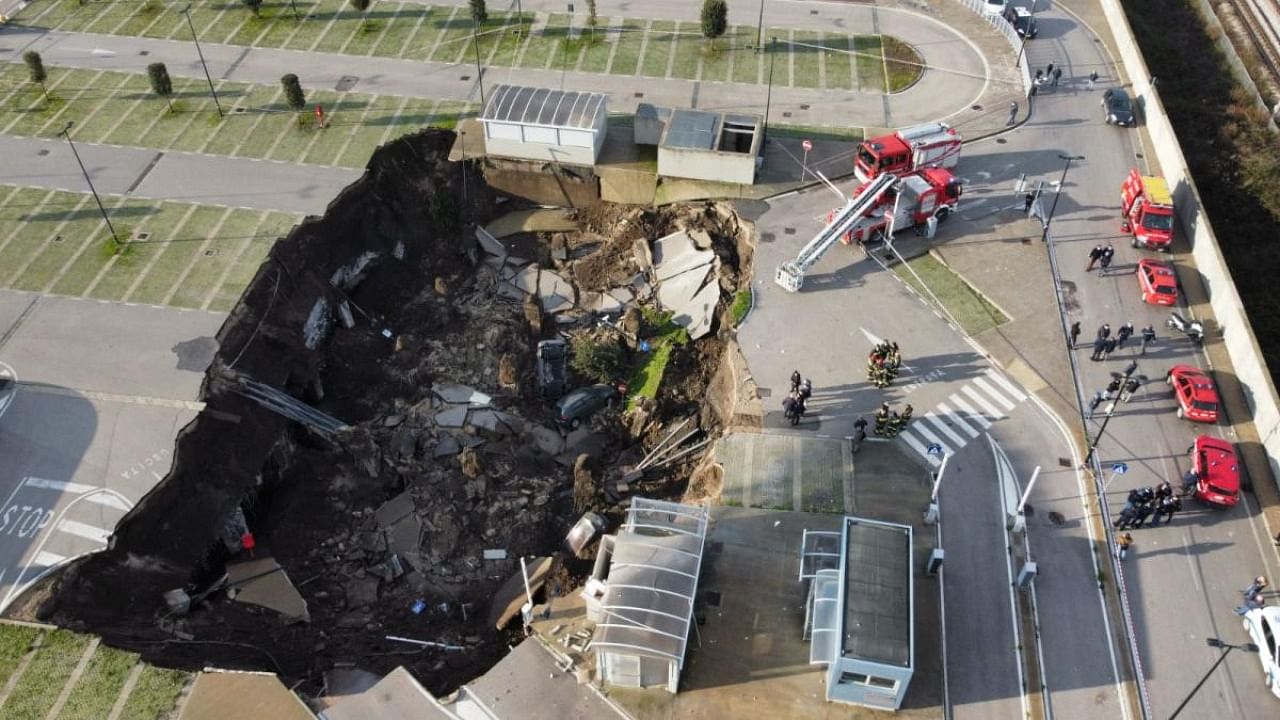  A aerial view shows a sinkhole in the Ospedale del Mare hospital car park, where people come for Covid-19 testing, on the outskirts of the city of Naples, after the ground collapsed early on January 8, 2021, destroying some vehicles. Credit: AFP.