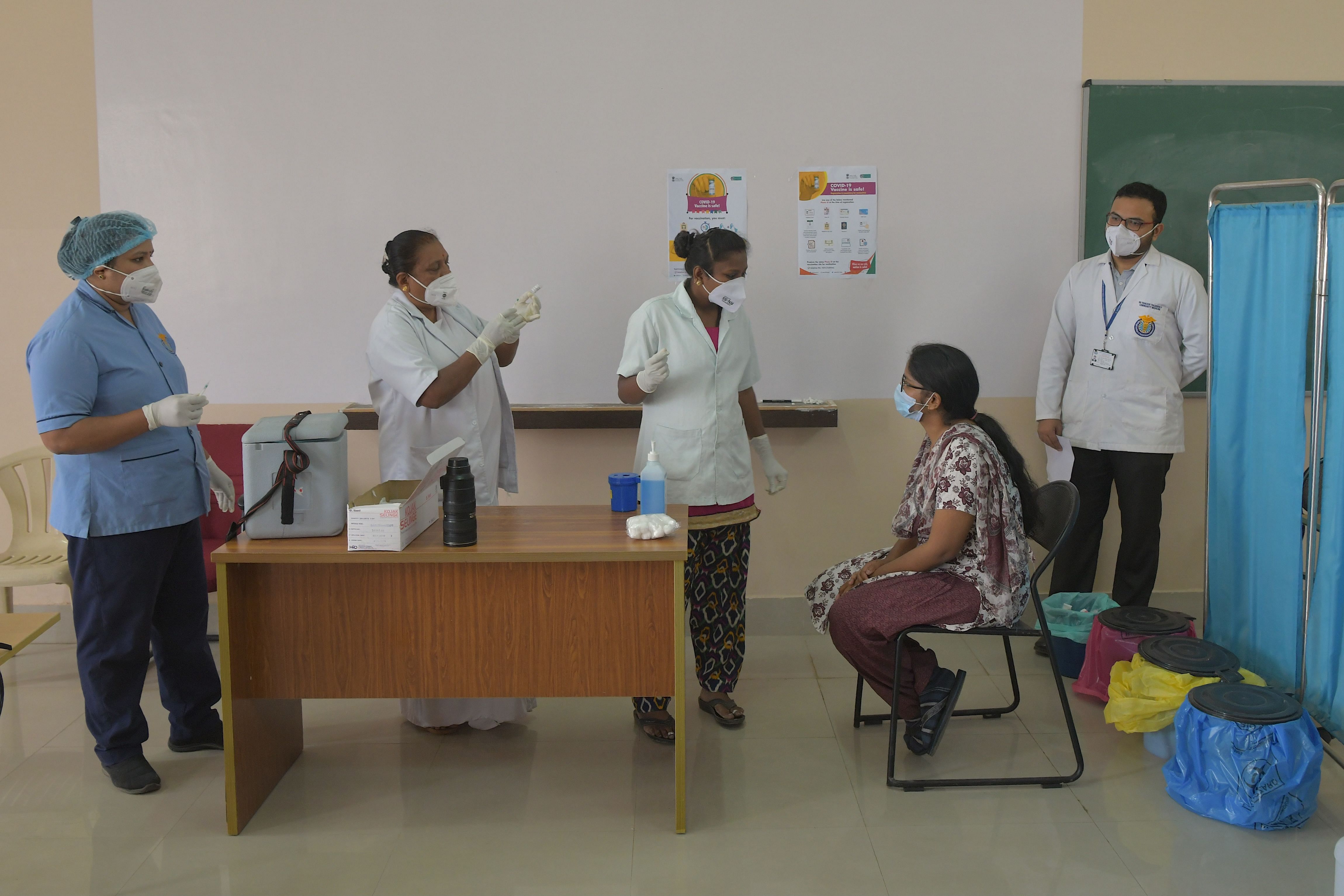 Health professionals brief a volunteer (2R) during a dry run or mock drill for the Covid-19 coronavirus vaccine delivery held at a private medical college. Credit: AFP Photo