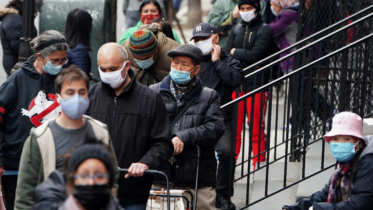 People wait in line at the St. Clements Food Pantry for food during the coronavirus disease. Credit: Reuters Photo