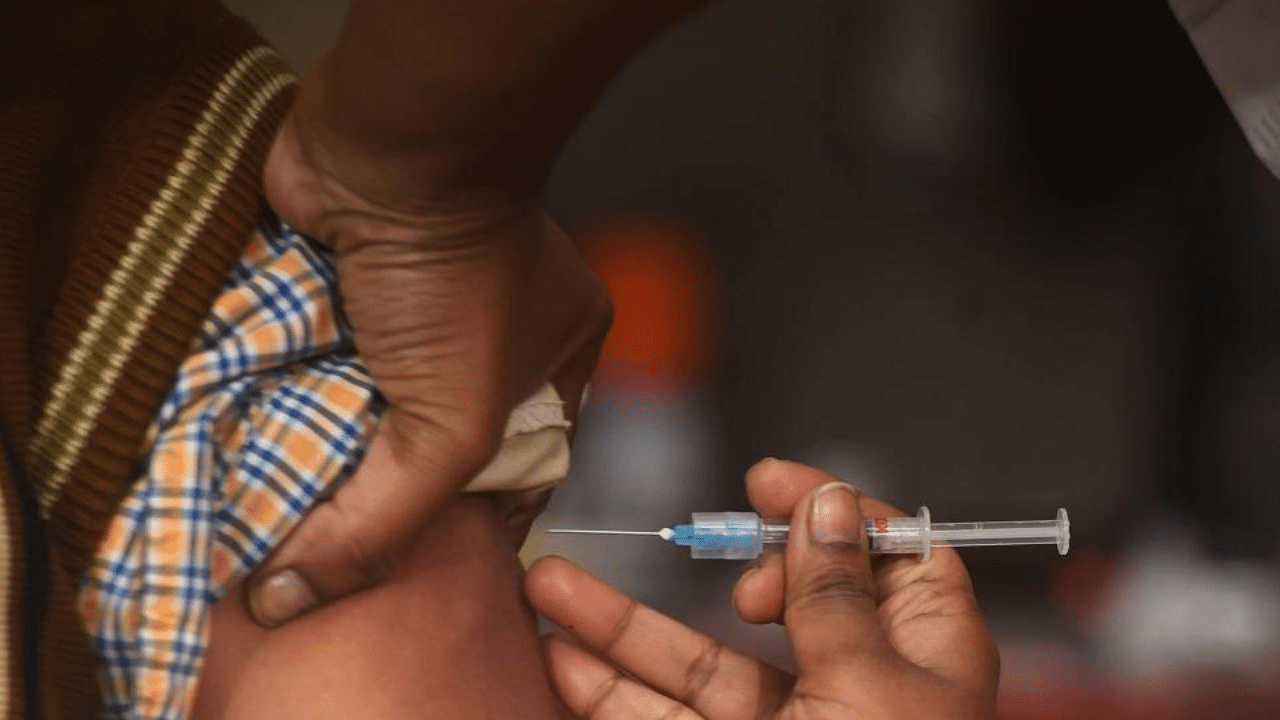 A health official (L) prepares to administer a vaccine during a dry run or a mock drill for Covid-19 coronavirus vaccine delivery at a primary health centre in Kolkata on January 2, 2021. Credit: AFP Photo