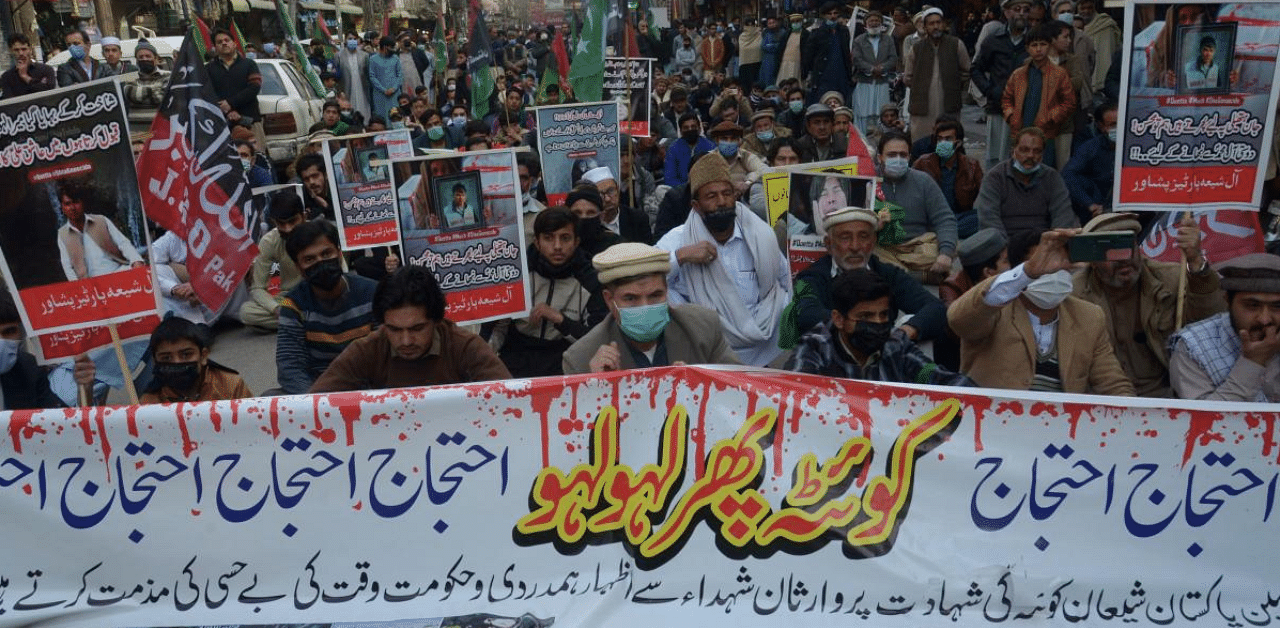 Shiite Muslims hold placards during a protest against the killing of miners of the Hazara Shiite community in an attack by gunmen in the mountainous Machh area, in Peshawar. Credit: AFP Photo