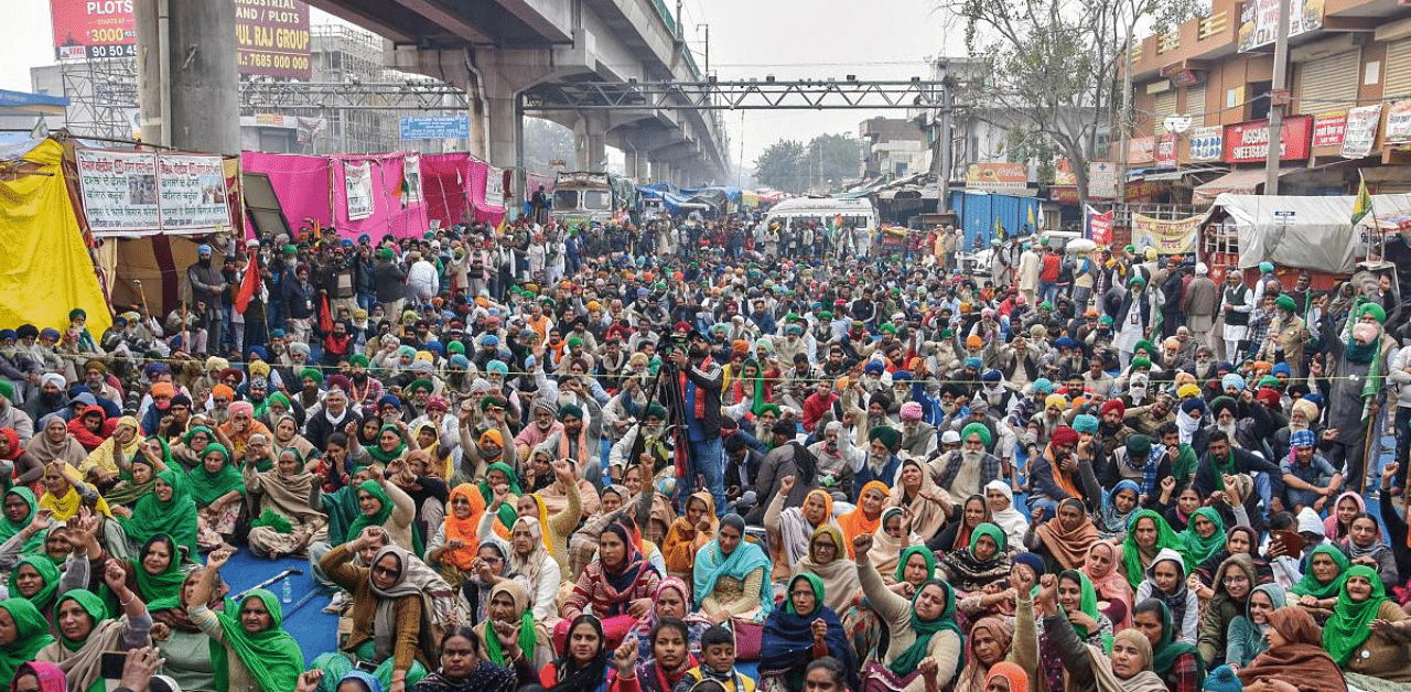 Farmers and their supporters during their ongoing protest against the new farm laws, at Tikri border. Credit: PTI Photo