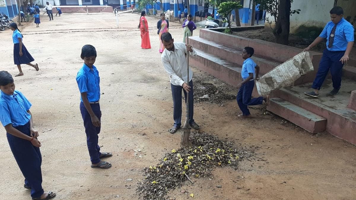 Satish Metri taking part in a cleanliness drive in a school. Photo by special arrangement
