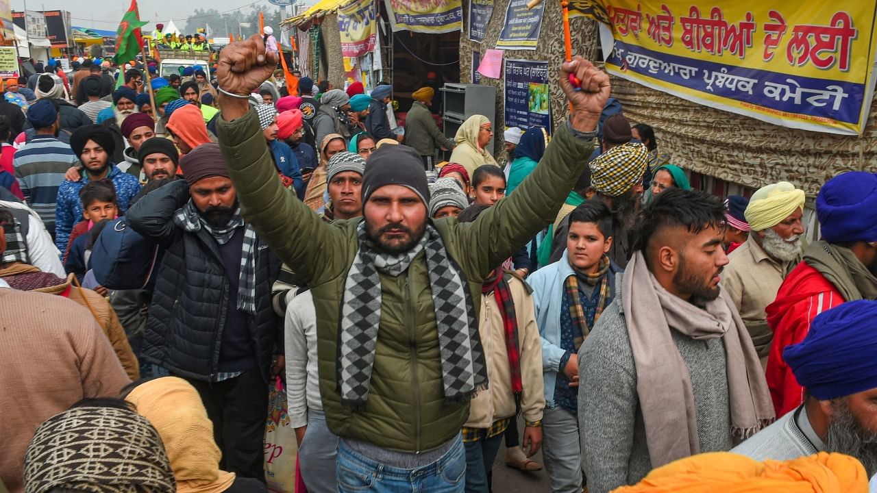 Farmers and their supporters during their ongoing protest against the new farm laws, at Singhu border in New Delhi. Credit: PTI Photo