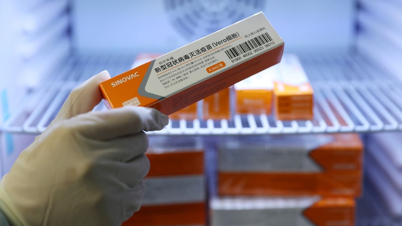 A medical worker takes a box of Sinovac's vaccine against the coronavirus disease. Credit: Reuters Photo