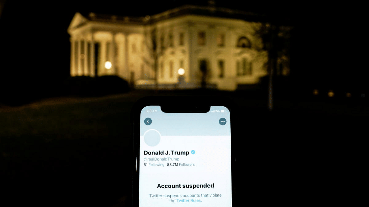 A photo illustration shows the suspended Twitter account of US President Donald Trump on a smartphone and the White House in Washington, US. Credit: Reuters File Photo