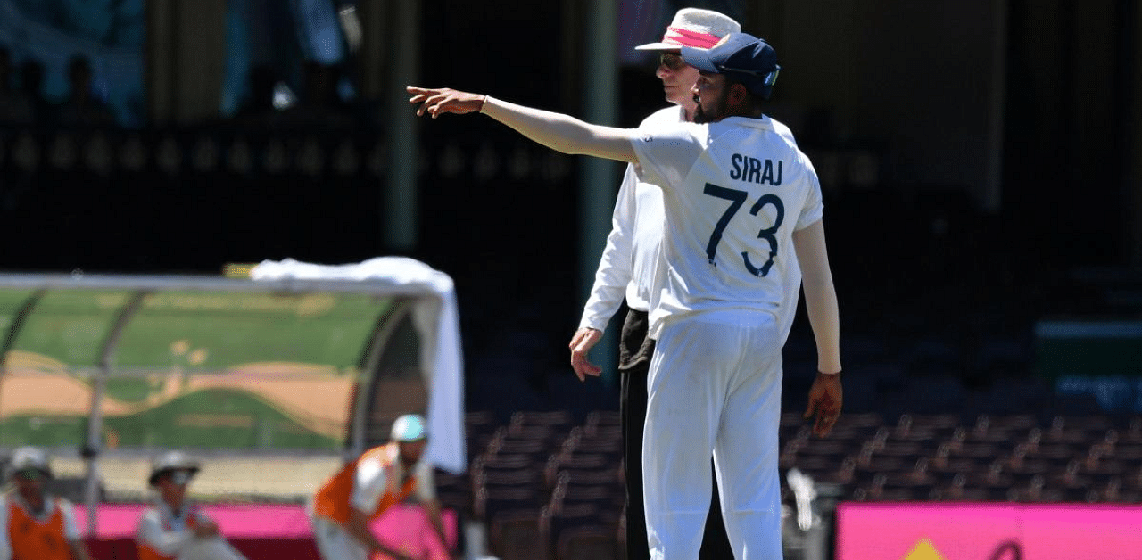 India's Mohammed Siraj gestures next to the umpire as the game was halted after allegedly some remarks were made by the spectators on the fourth day of the third cricket Test match between Australia and India at the Sydney Cricket Ground (SCG) in Sydney. Credit: AFP Photo