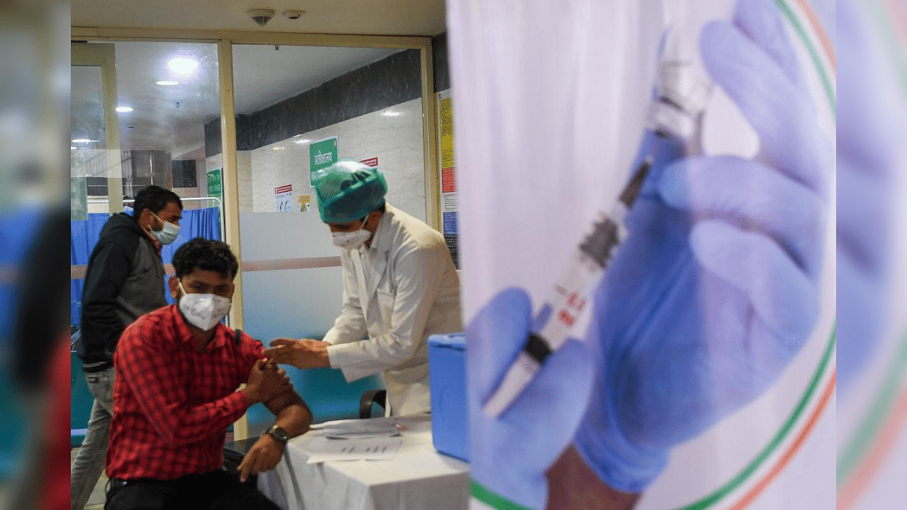 A health official and a volunteer (L) take part in dry run or a mock drill for the Covid-19 coronavirus vaccine delivery at Northen Railways hospital in New Delhi on January 8, 2021. Credit: AFP Photo