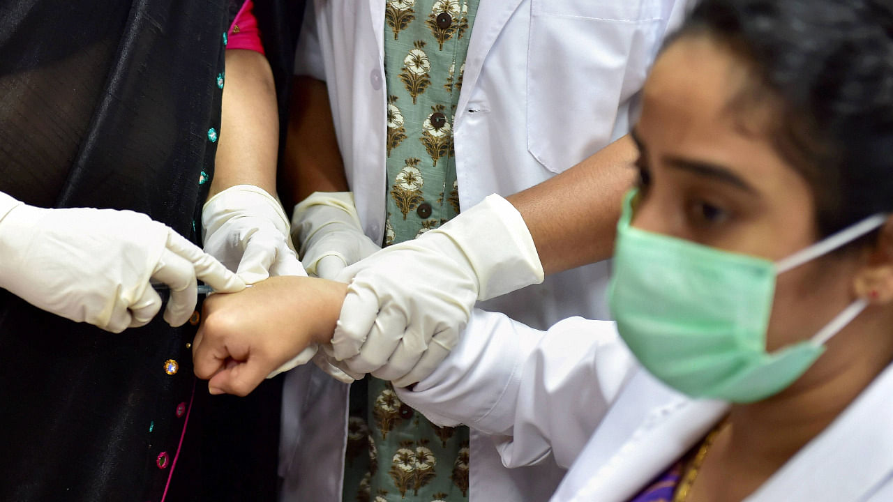 A volunteer takes part in the dry run of the Covid-19 vaccine at a civil hospital in Bengaluru. Credit: PTI Photo
