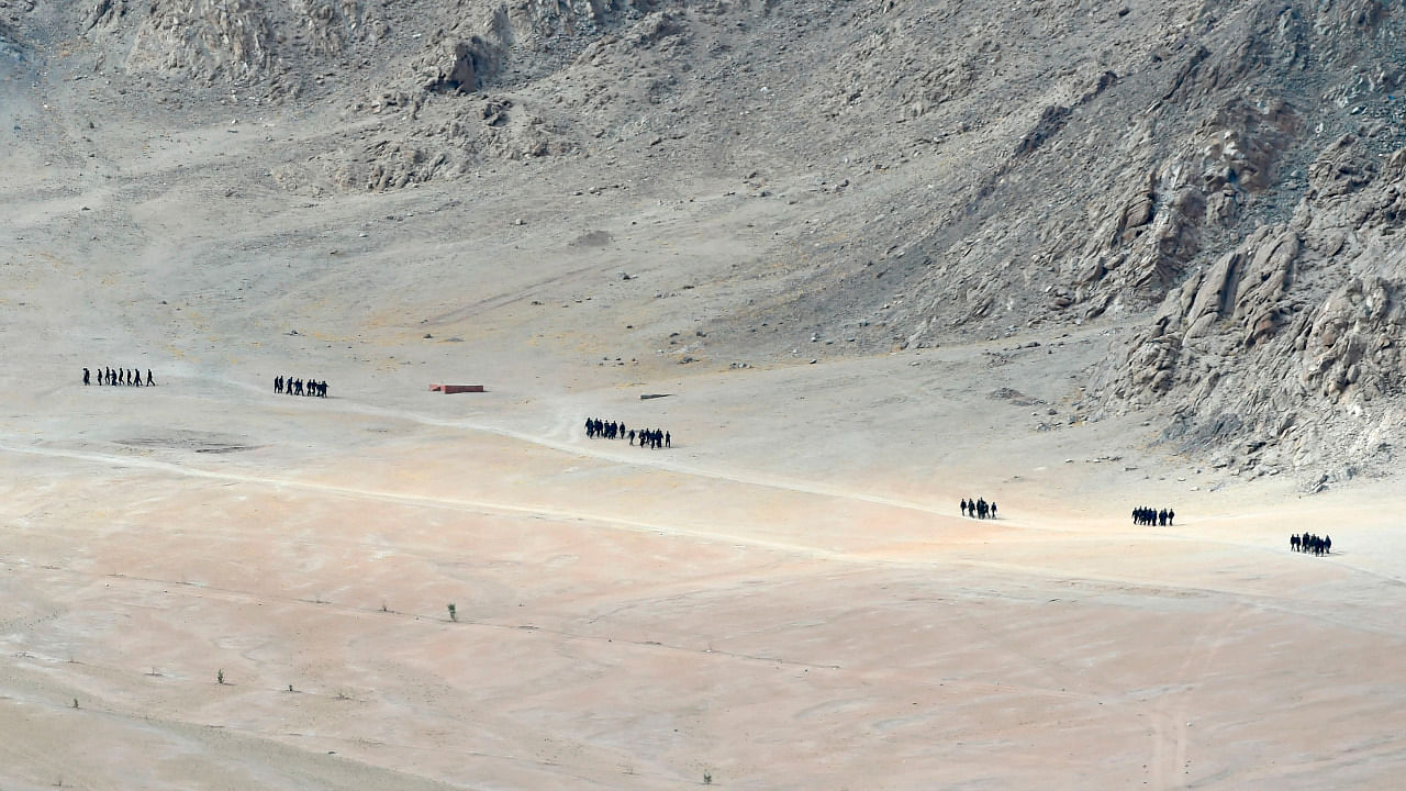 Indian soldiers walk at the foothills of a mountain range near Leh. Credit: AFP File Photo