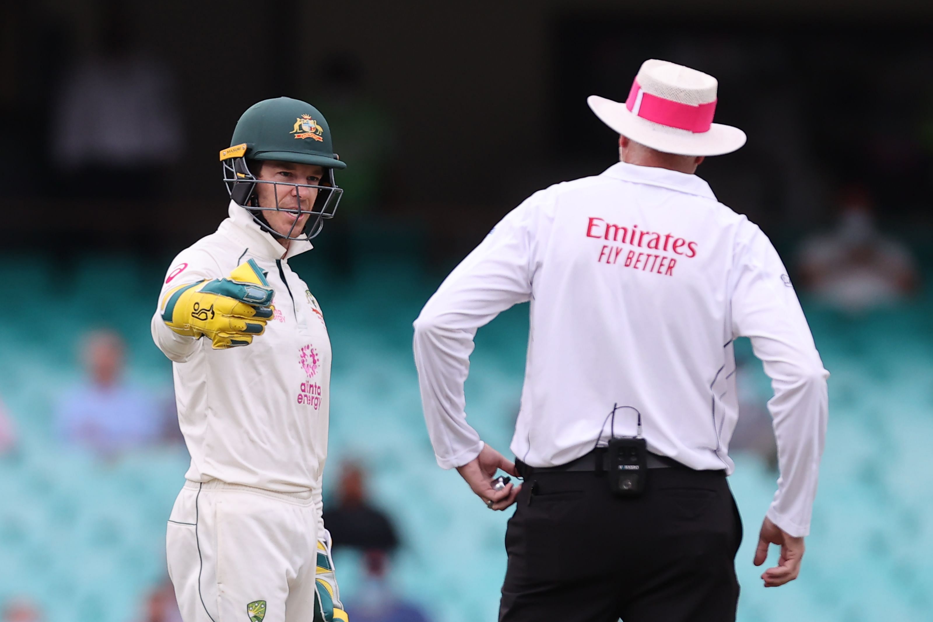 Australia's captain Tim Paine (L) speaks with an umpire during the second day of the third cricket Test match between Australia and India at the Sydney Cricket Ground. Credit: AFP