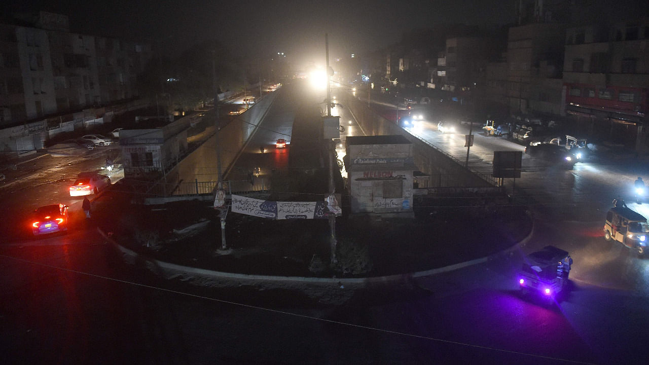 Motorists drive through a residential area during a power blackout in Pakistan's port city of Karachi. Credit: AFP Photo