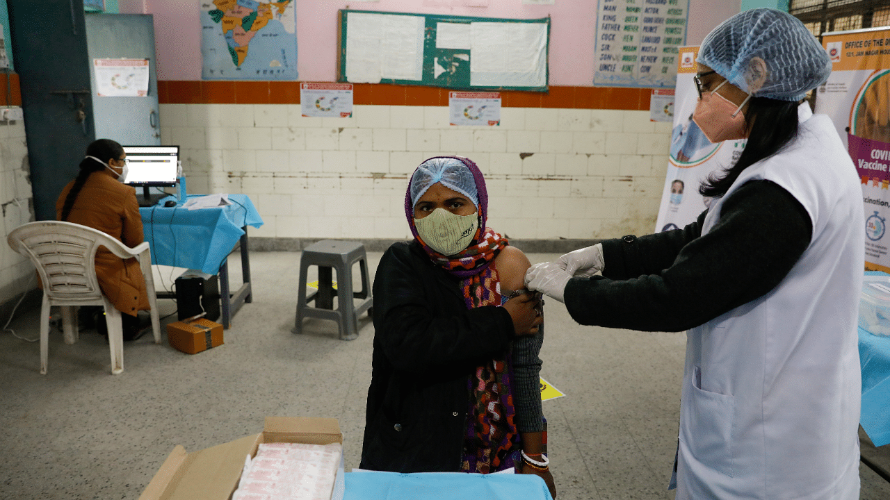 A health worker and a volunteer take part in a nationwide trial run of coronavirus disease. Credit: Reuters Photo