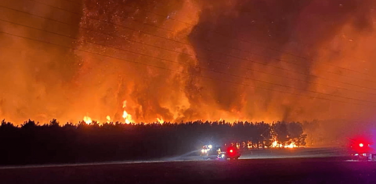 Smoke and flames from bushfire are seen in Gingin, Australia. Credit: Reuters Photo