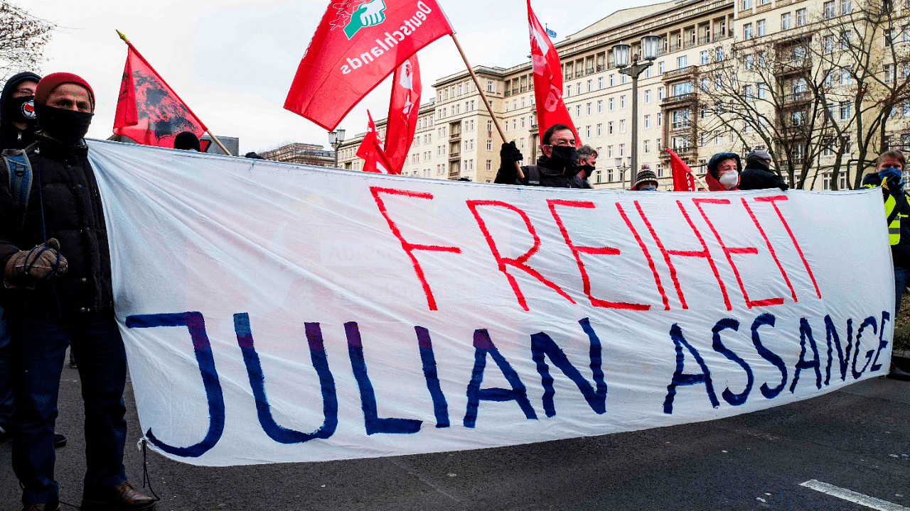 Demonstrators display a banner reading: "Freeedom for [Wikileaks founder] Julian Assange" during a yearly demonstration held by various parties. Credit: AFP Photo