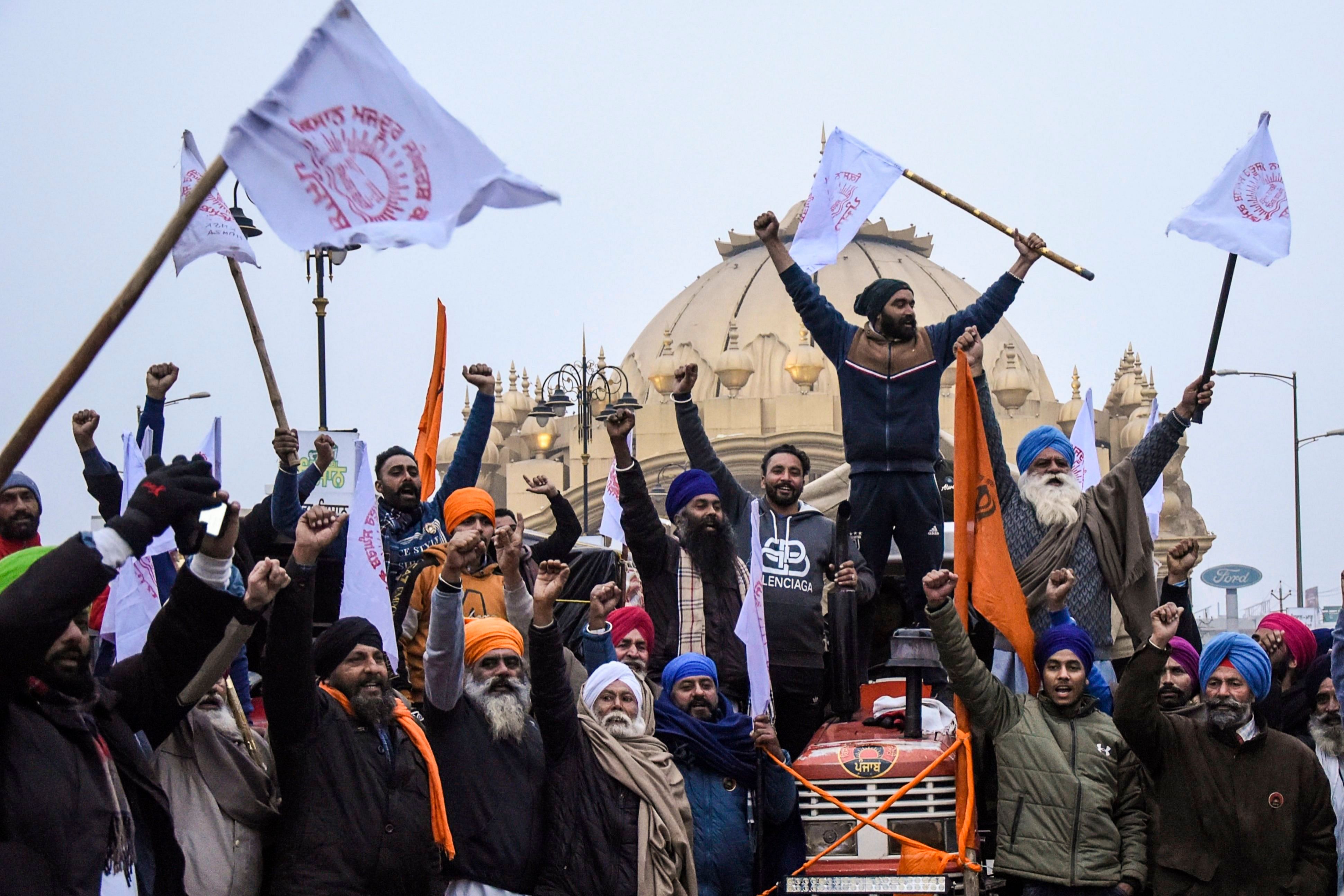 Farmers shout slogans as they depart for Delhi to participate in a continuing demonstration against the central government's recent agricultural reforms in Amritsar on January 12, 2021. Credit: AFP Photo