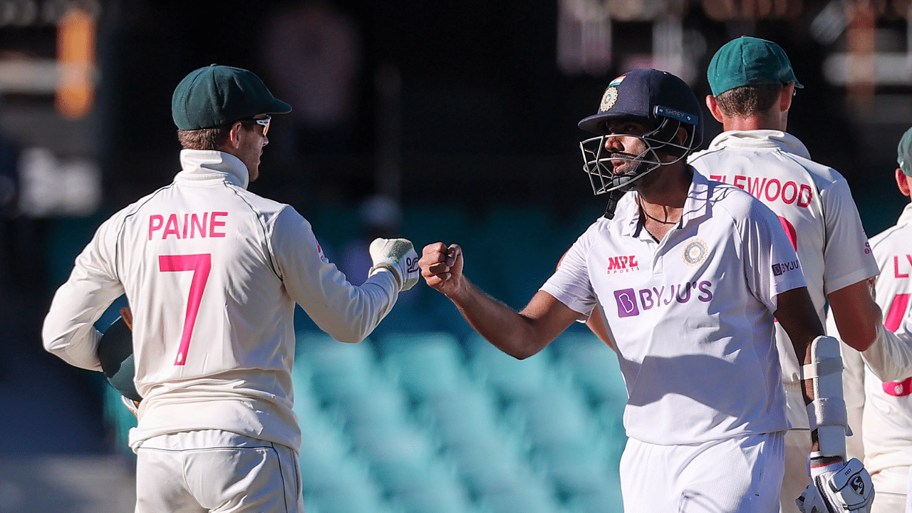 India's Ravichandran Ashwin (R) fist bumps with Australia's captain Tim Paine at the end of the third cricket Test match between Australia and India at the Sydney Cricket Ground (SCG) in Sydney. Credit: AFP File Photo