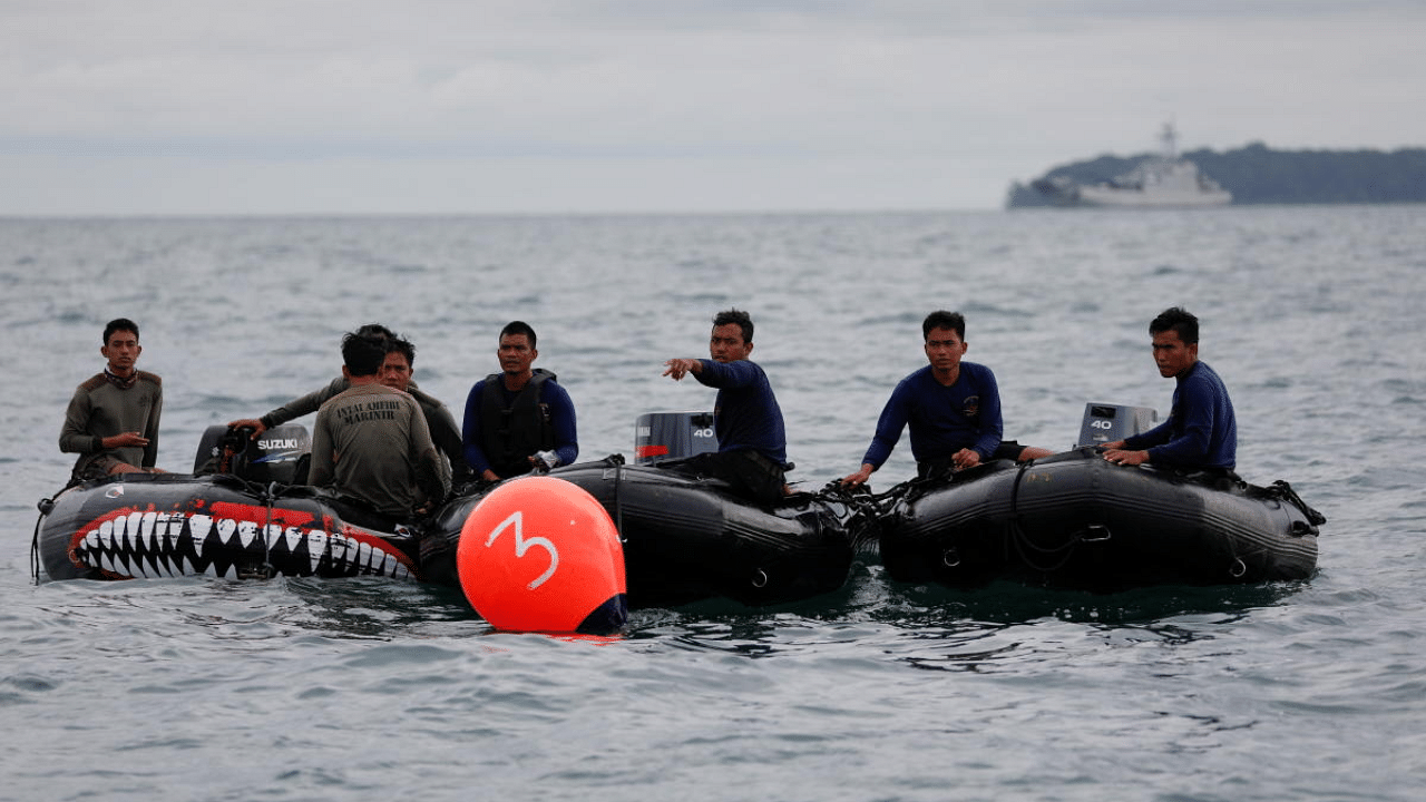 Indonesian navy divers are seen on rubber boats during the search and rescue operation for the Sriwijaya Air flight SJ 182, at the sea off the Jakarta coast, Indonesia. Credit: Reuters Photo