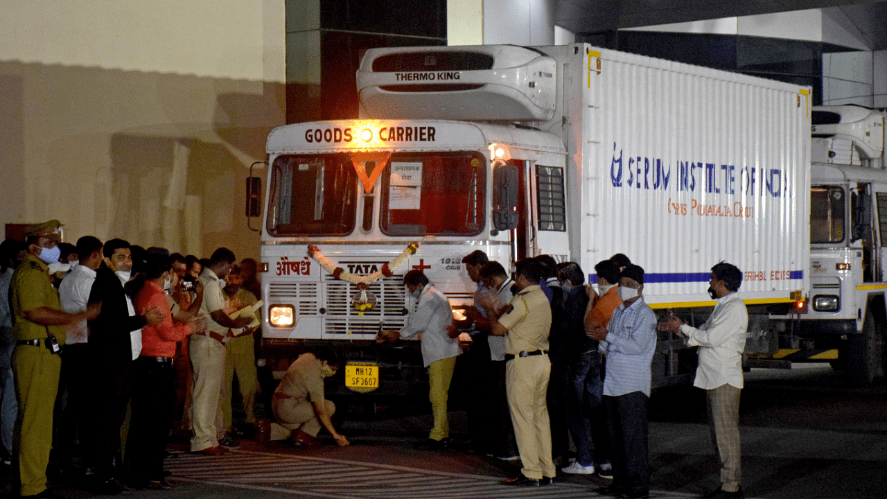 A police officer performs prayers in front of a truck carrying first consignment of COVISHIELD, a coronavirus disease vaccine developed by AstraZeneca and Oxford University, before it leaves from Serum Bio-Pharma Park of Serum Institute of India, for its distribution, in Pune, India. Credit: Reuters Photo