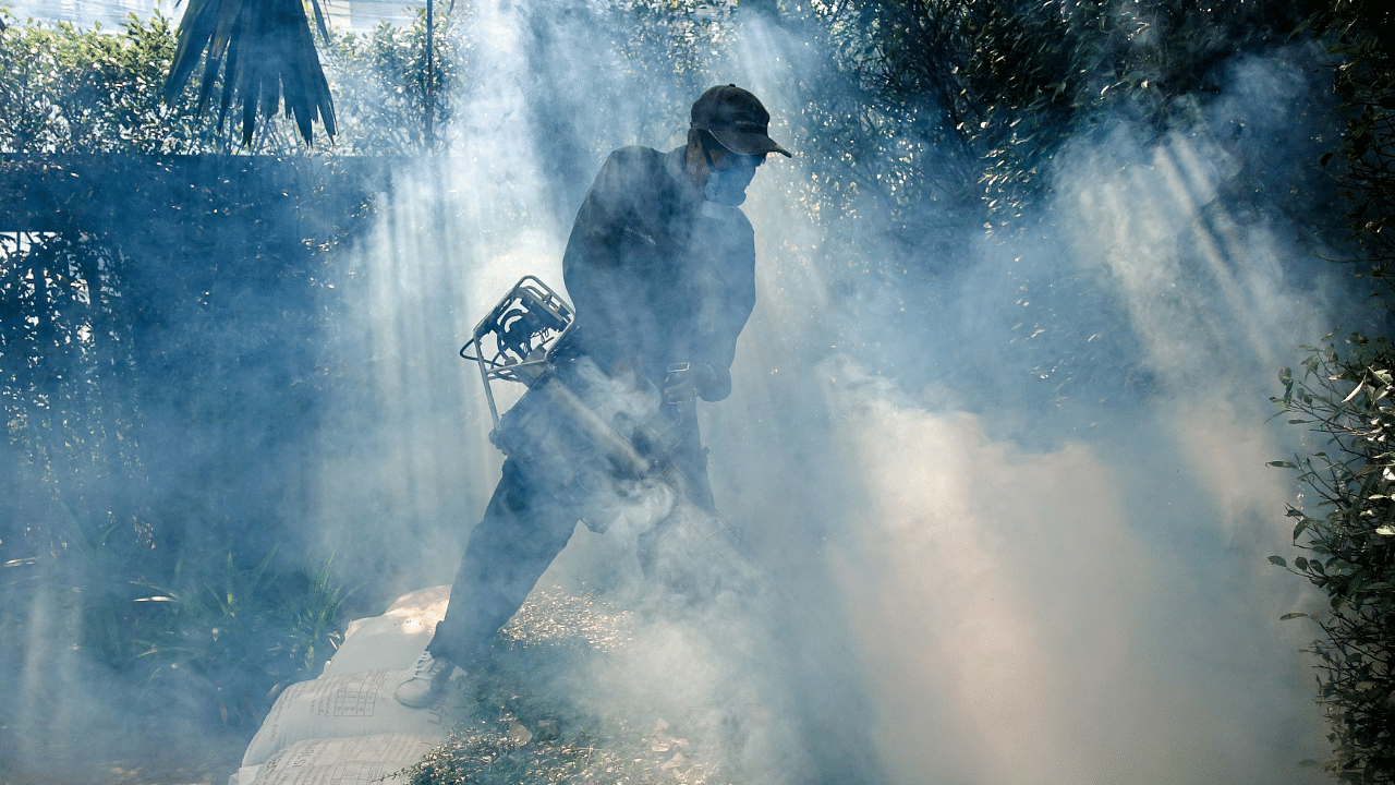 A worker sprays insecticide for mosquitos at a village in Bangkok, Thailand. Credit: Reuters File Photo