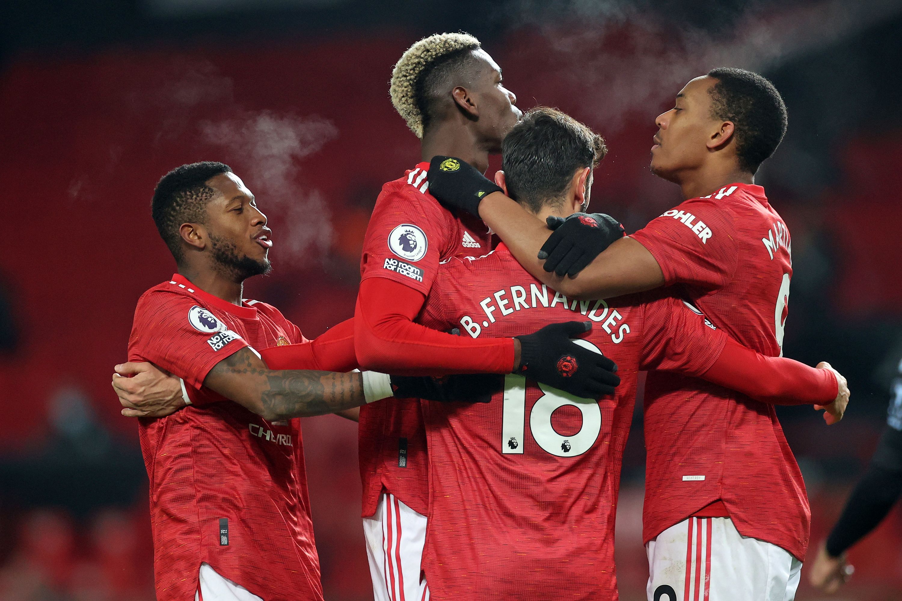 Manchester United's Portuguese midfielder Bruno Fernandes (C) celebrates with teammates after scoring their second goal from the penalty spot during the English Premier League football match between Manchester United and Aston Villa at Old Trafford in Manchester, north west England, on January 1, 2021. Credit: AFP File Photo