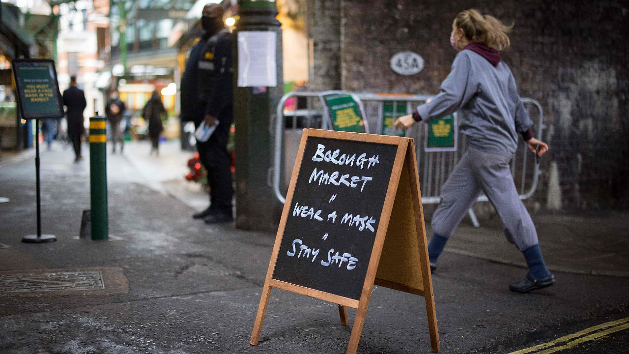 A sign informs people that it is mandatory to wear face masks at Borough Market in London. Credit: AFP Photo