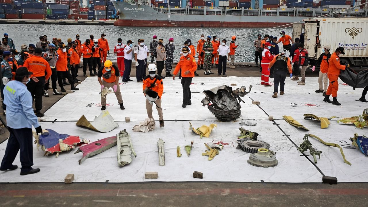 Parts of aircrafts found on the waters off Java Island where a Sriwijaya Air passenger jet crashed are laid out for inspection, at Tanjung Priok Port in Jakarta, Indonesia. Credit: AP/PTI Photo
