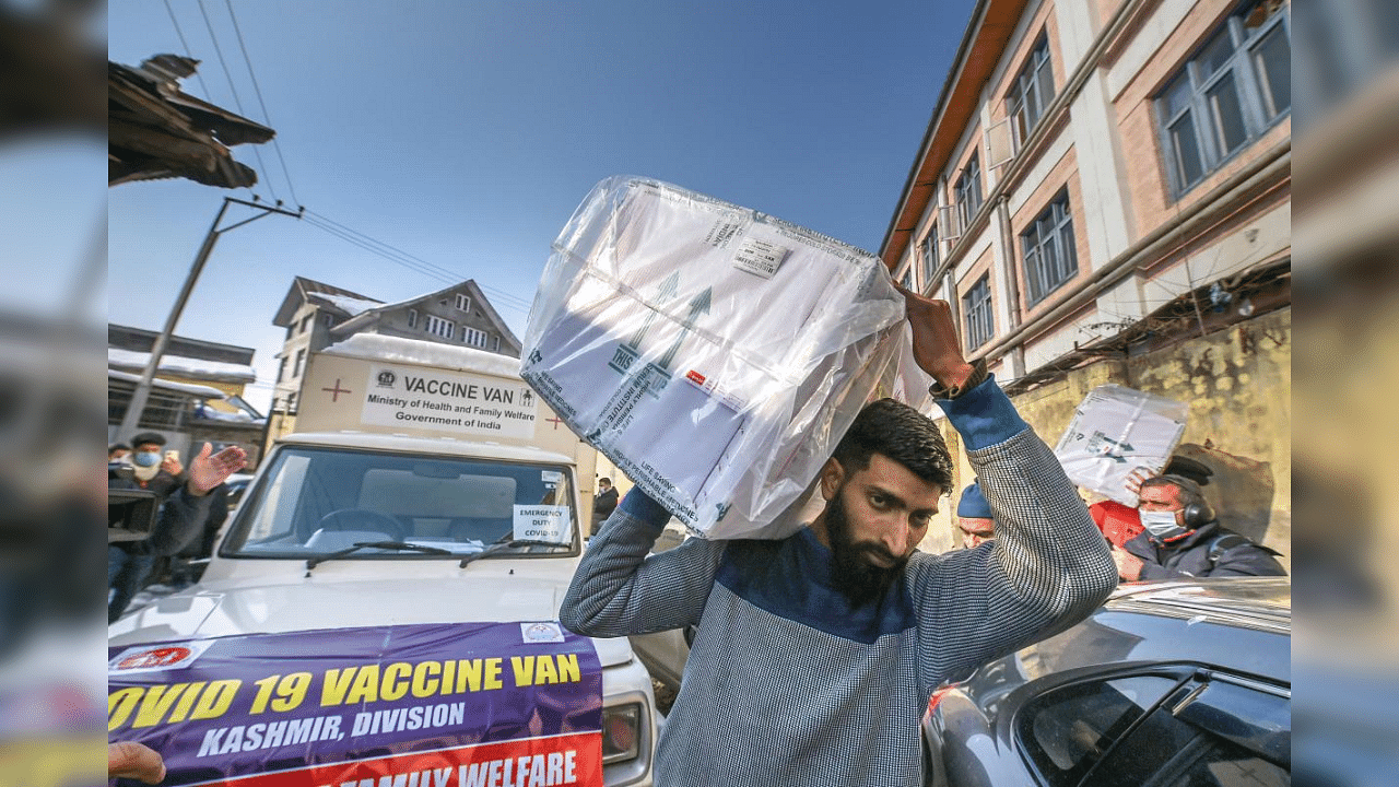 Medical department workers unload boxes of Covid-19 vaccines from a vehicle at cold storage of a hospital, in Srinagar, Wednesday, Jan. 13, 2021. Credit: PTI Photo