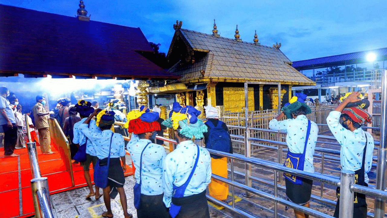  Devotees maintain social distance while standing in queues to offer prayers at Lord Ayyappa temple on the 1st day of Malayalam month of 'Vrischikom, at Sabarimala in Pathanamthitta, Monday, Nov. 16, 2020. Credit: PTI Photo