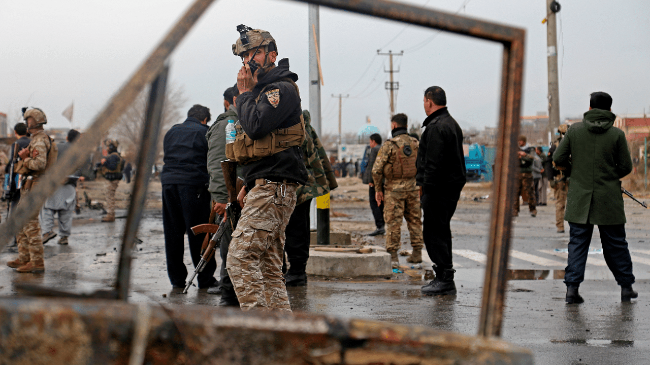 Members of Afghan security forces stand guard at the site of an attack in Kabul. Credit: AFP Photo