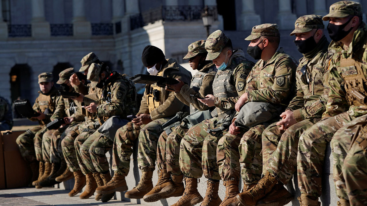 National Guard members eat lunch and rest outside the US Capitol, as Democrats debate one article of impeachment against US President Donald Trump. Credit: Reuters Photo