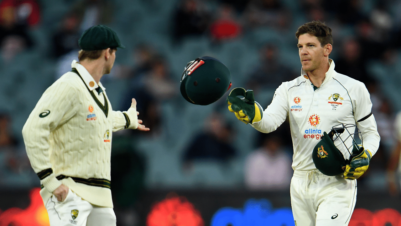 Australia's captain Tim Paine (R) throws a helmet towards Steve Smith during the day one of the first cricket Test match between Australia and India in Adelaide. Credit: AFP File Photo