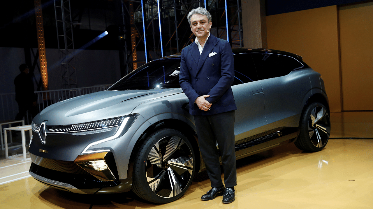 Luca de Meo, Chief Executive Officer of Groupe Renault, poses in front of a Renault Megane eVision car during a news conference. Credit: Reuters File Photo