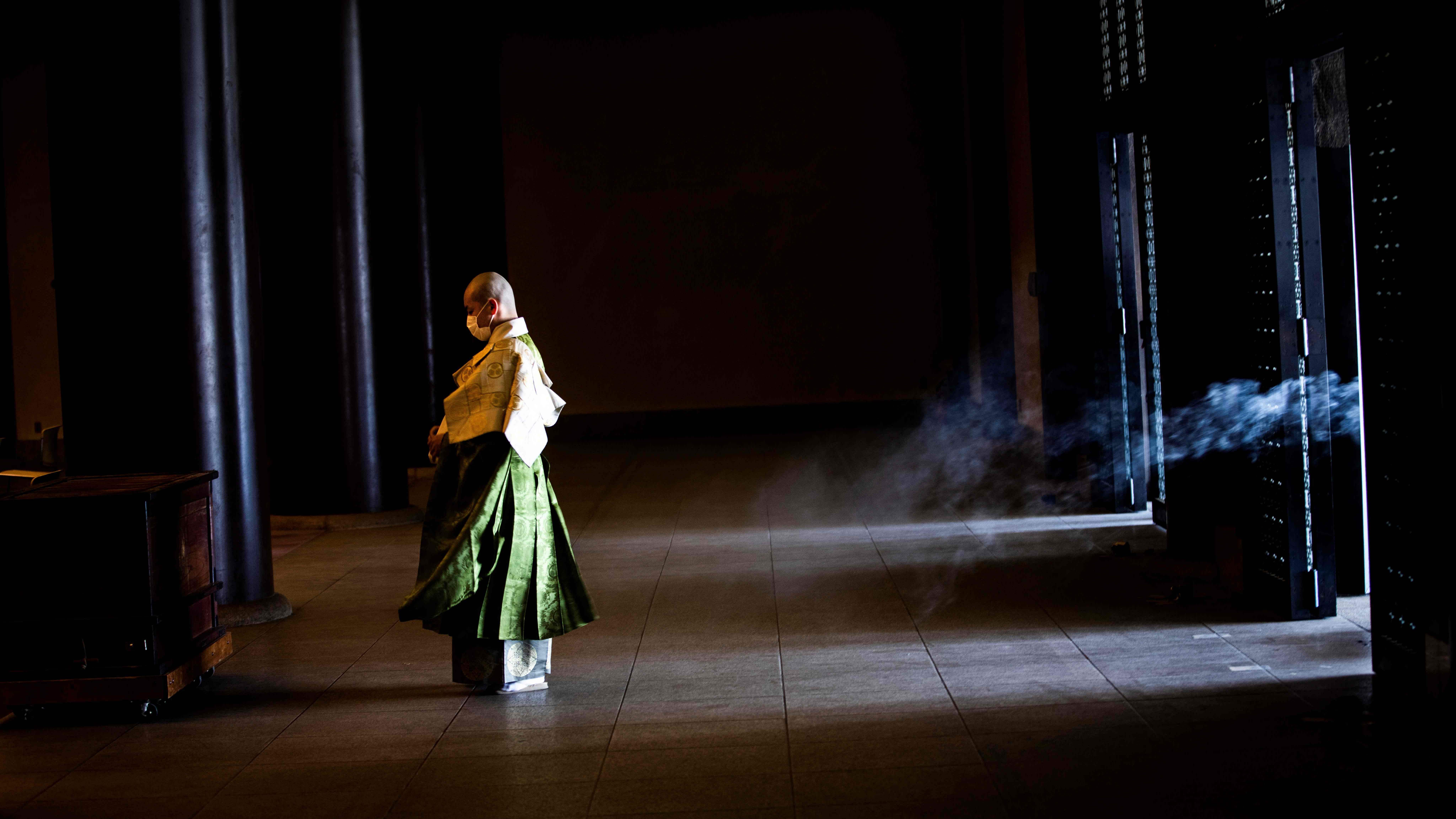 A Buddhist monk prepares ahead of daily prayers to pray for the end of the COVID-19 coronavirus pandemic at Zojoji Temple in Tokyo. Credit: AFP