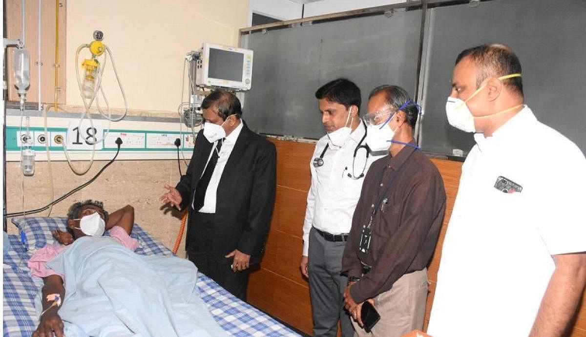 Dr C N Manjunath speaks to patients at Jayadeva Hospital in Mysuru on Friday. DH PHOTO