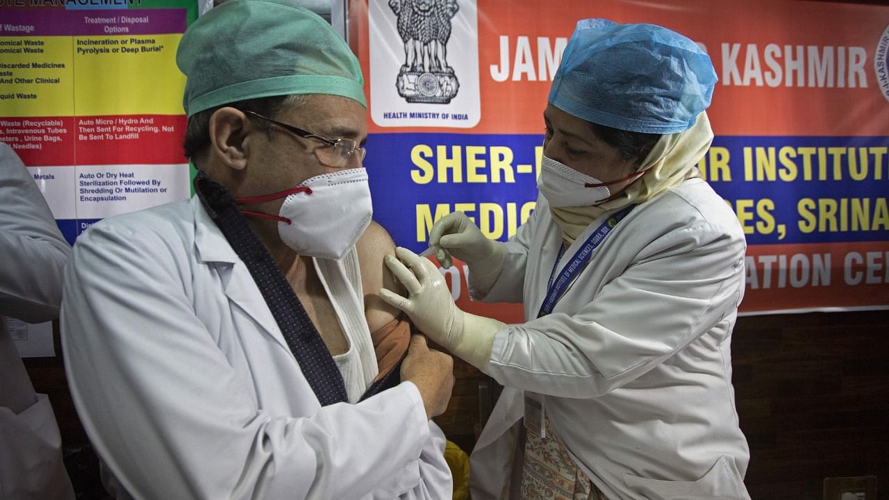 A doctor inoculates her colleague with a Covid-19 vaccine at a hospital on January 16, 2021. Credit: AFP Photo