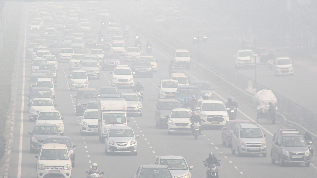 Vehicles move slowly amid low visibility due to dense fog on a cold winter morning, at Delhi-Gurugram Experssway in Gurugram. Credit: PTI Photo