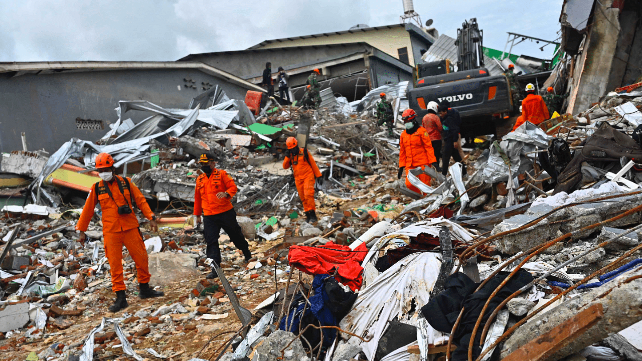 Rescuers search for survivors at a collapsed building in Mamuju city on January 16, 2021, a day after a 6.2-magnitude earthquake rocked Indonesia's Sulawesi island. Credit: AFP Photo